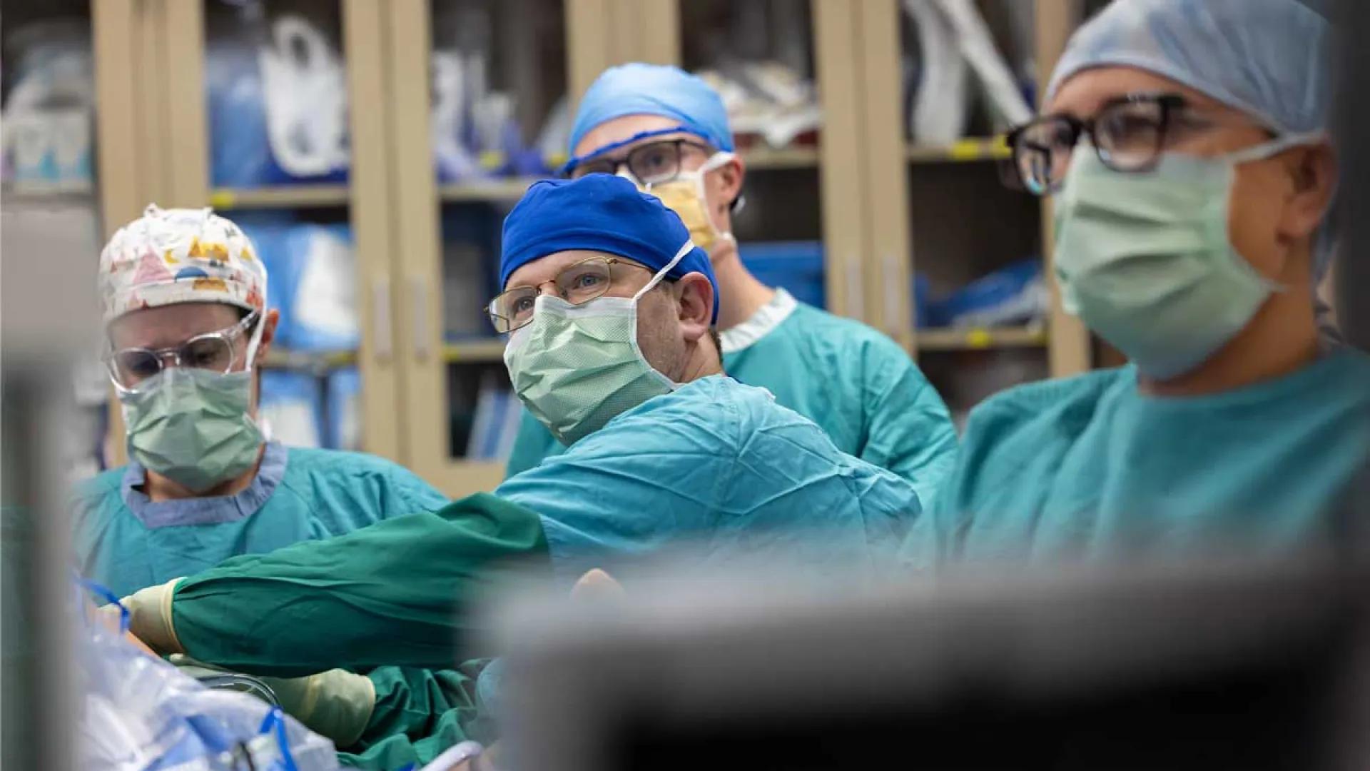 Doctors perform surgery on a patient.