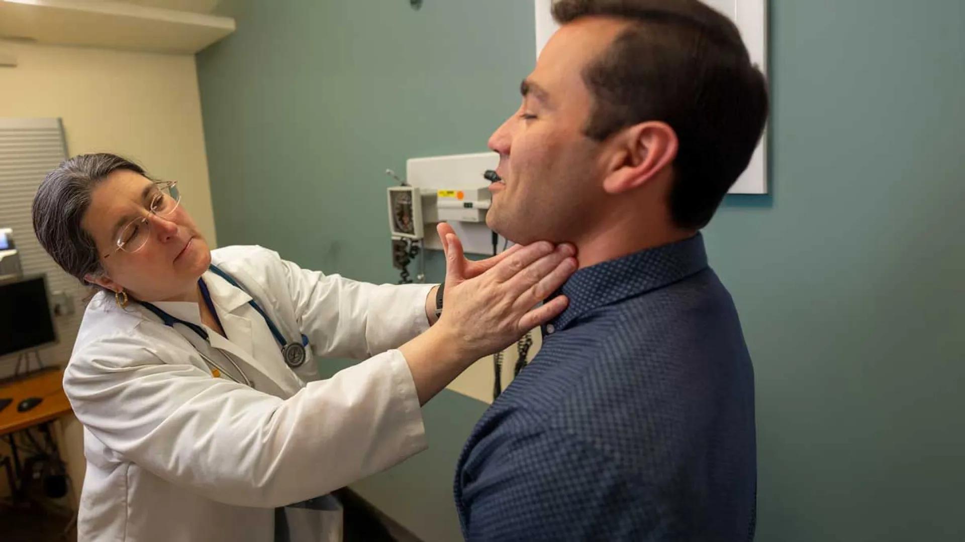 A doctor examines an adult male patient. 