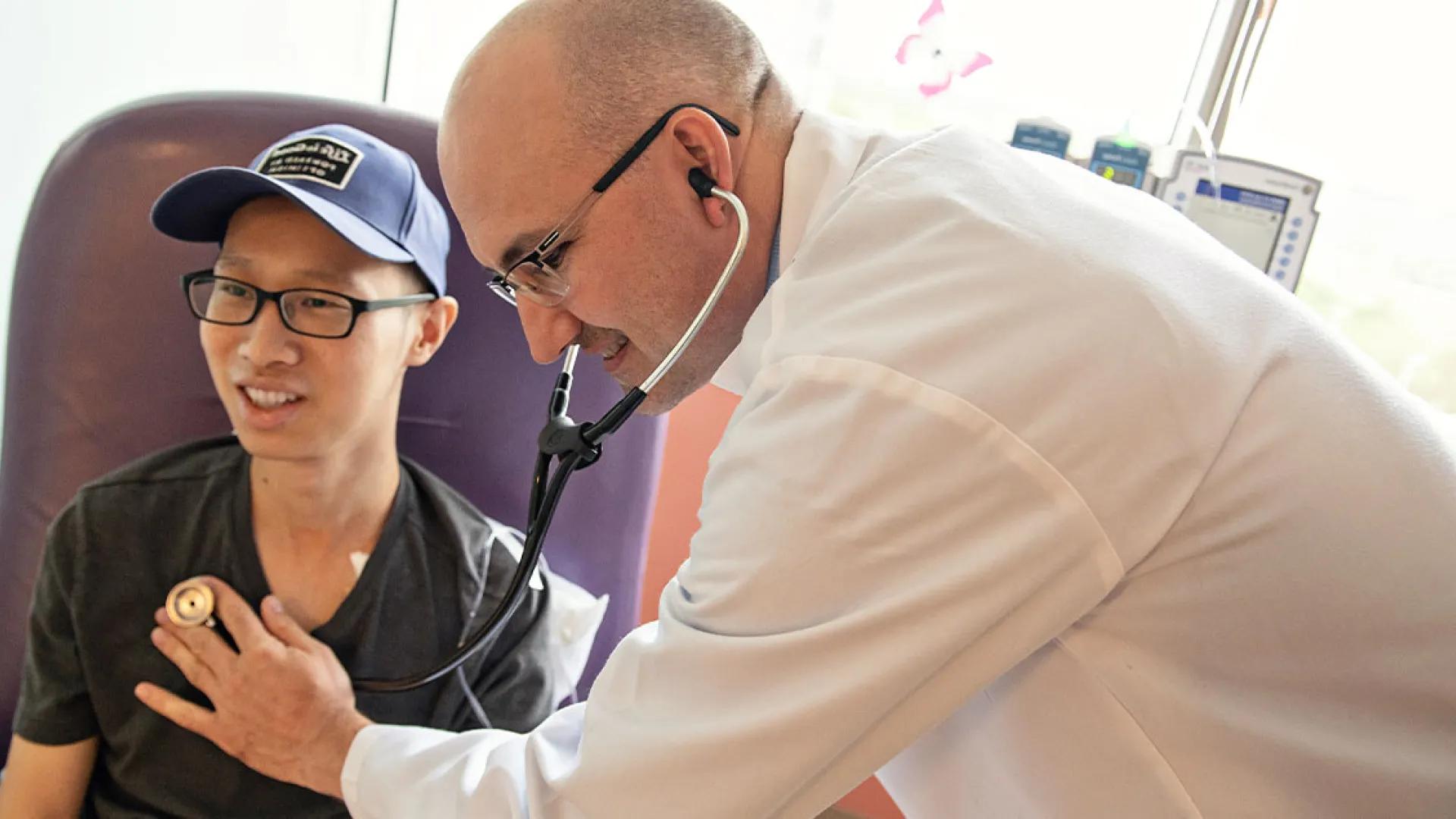 Dr. John Mageneau with a bone marrow transplant patient