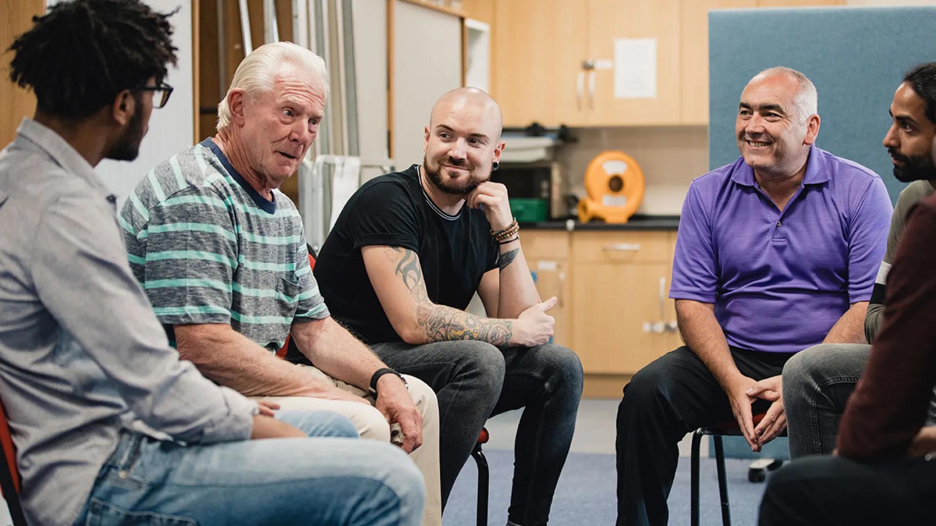 Multigenerational group of men talking