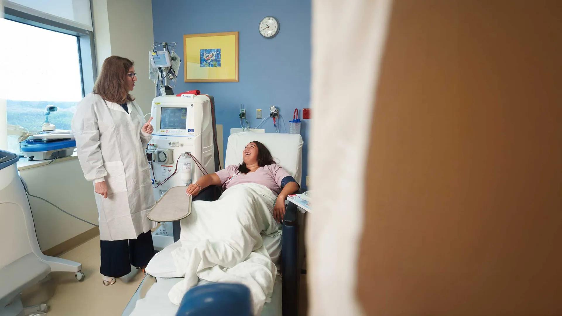 Patient and Physician talk and laugh together. 