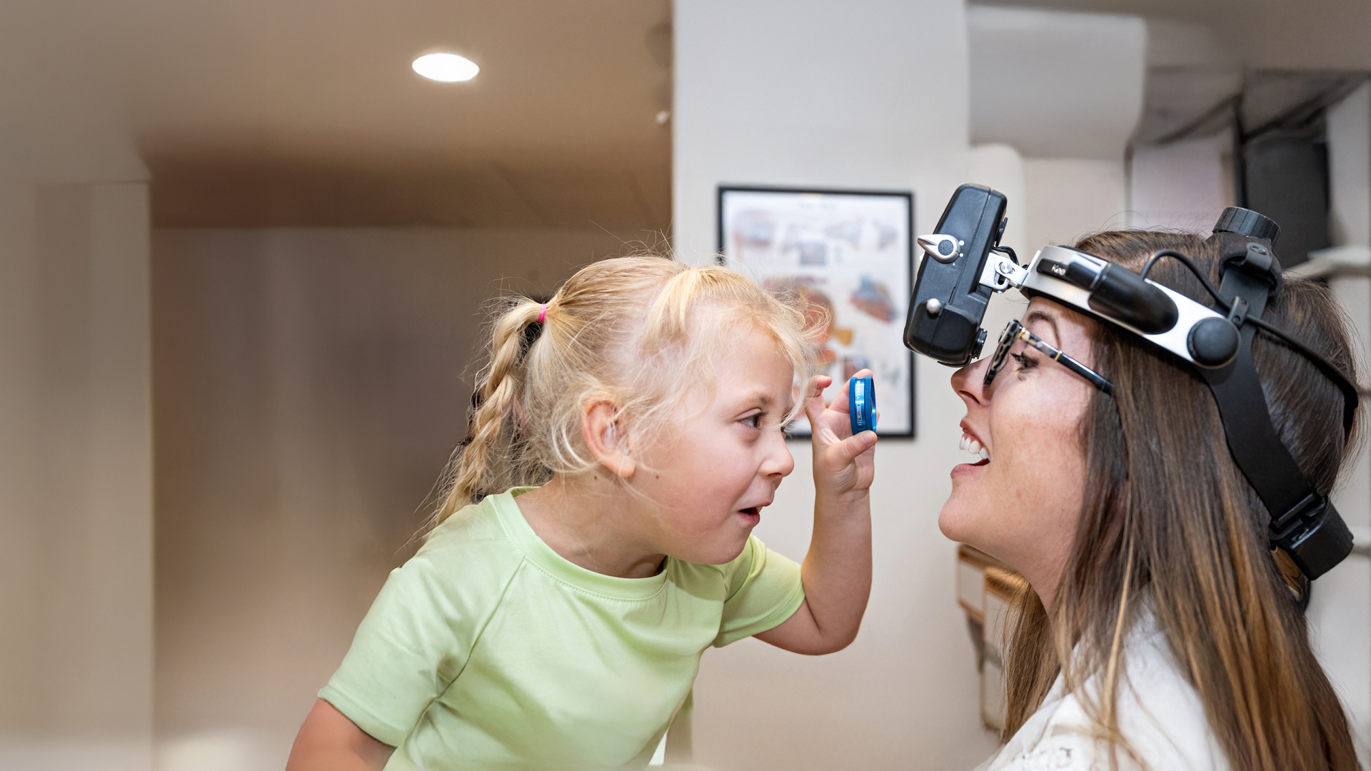 Child with doctor giving an eye exam