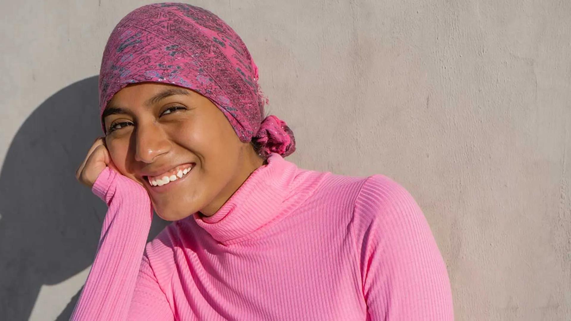 Indigenous women in pink head scarf and sweater