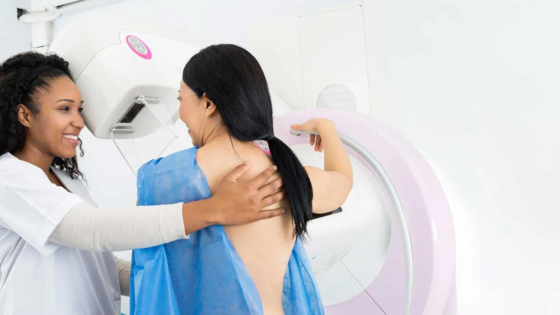 Black technician helps Asian woman get a mammogram