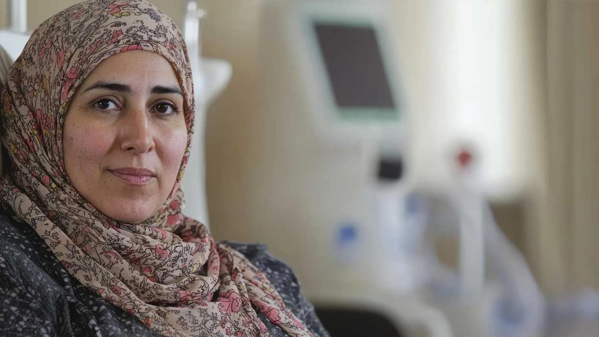 Mature woman with hajib getting chemotherapy treatment