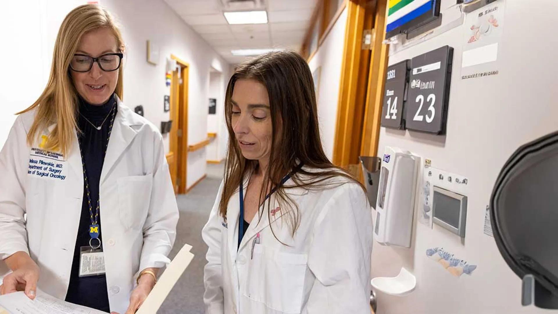 Drs. Melissa Pilewski and Monika Burness discuss a patient's care plan