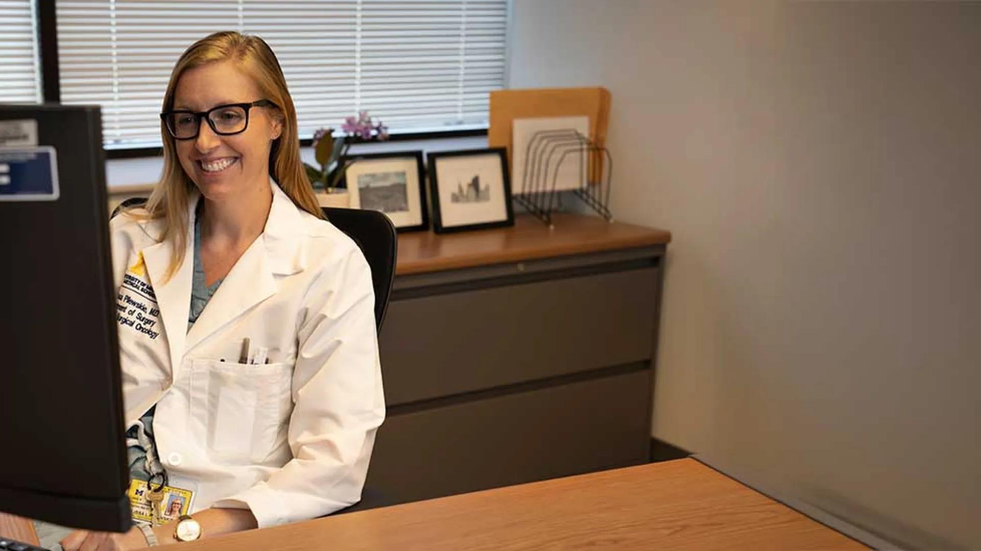 Dr. Melissa Pilewski sits at her computer
