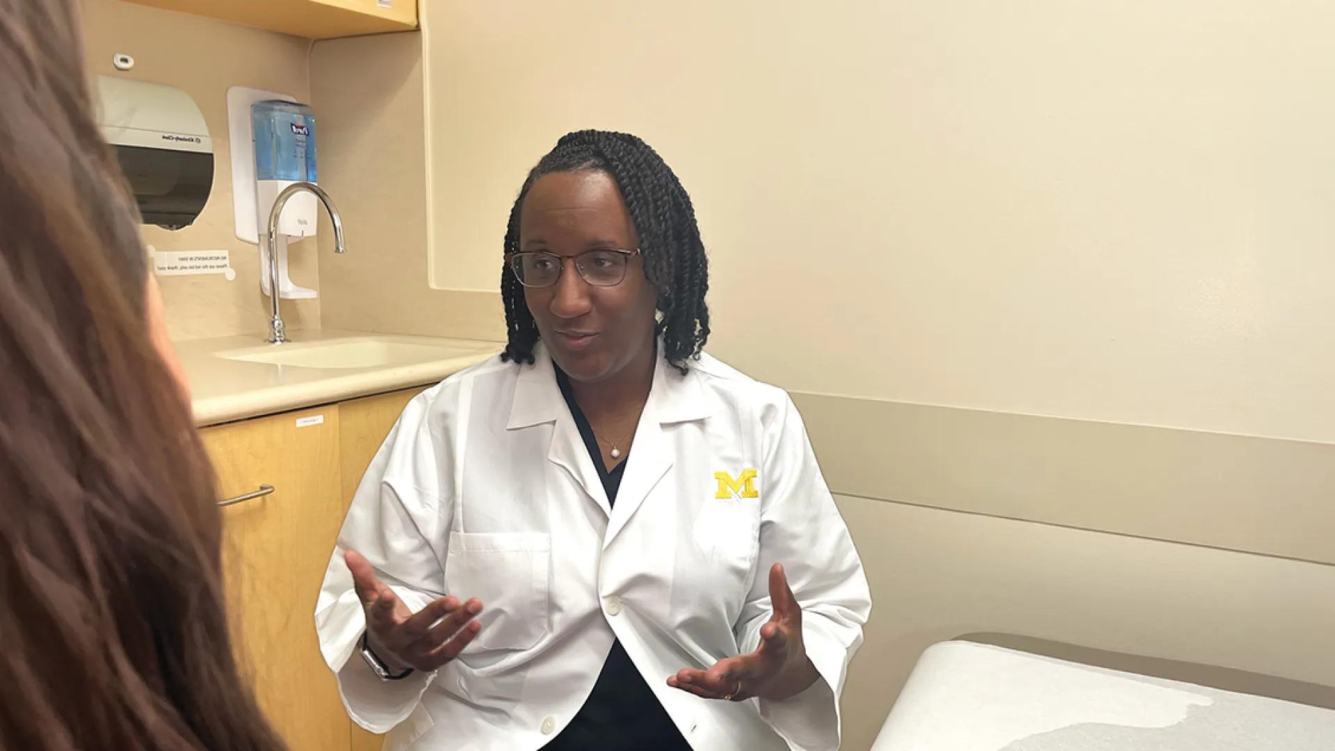 A surgeon discusses surgery with a patient.
