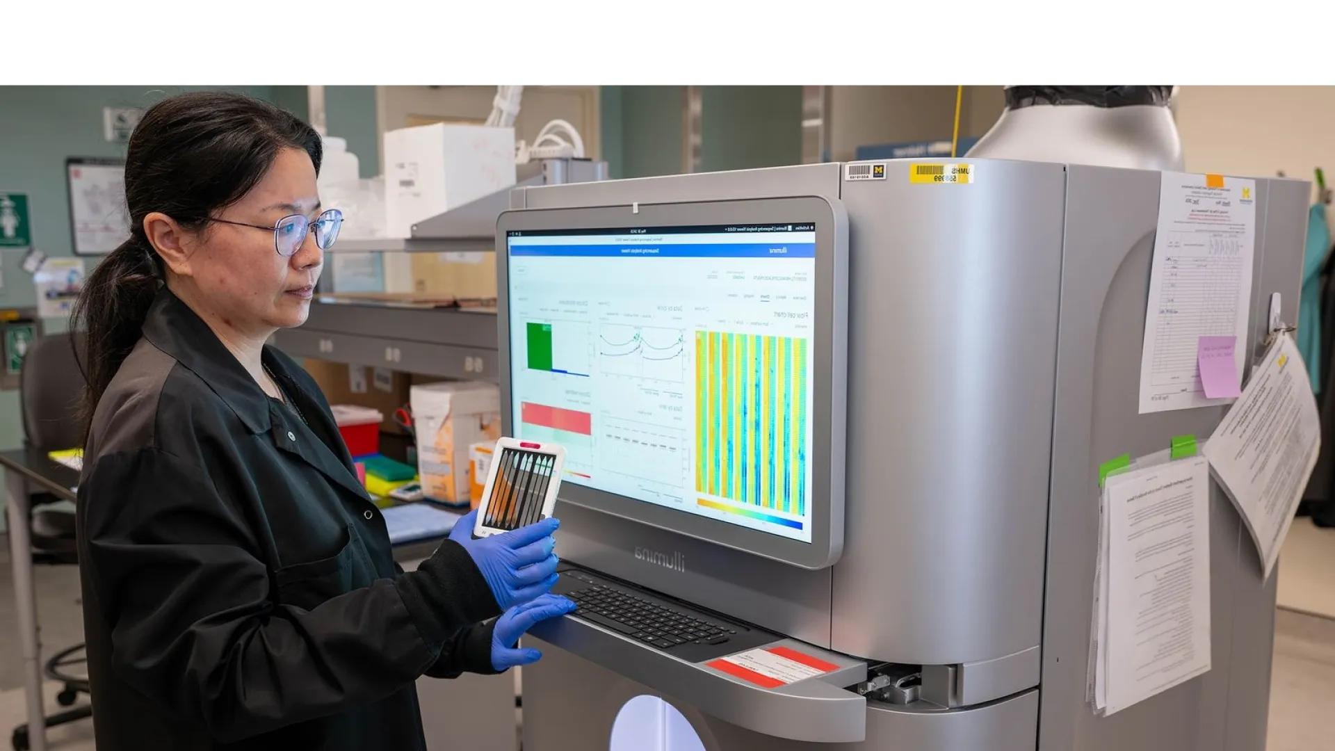 Lab member analyzes data from workstation.