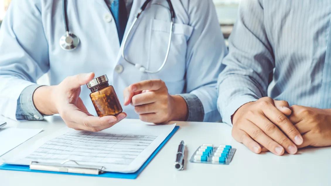 Doctor showing prescription to patient.