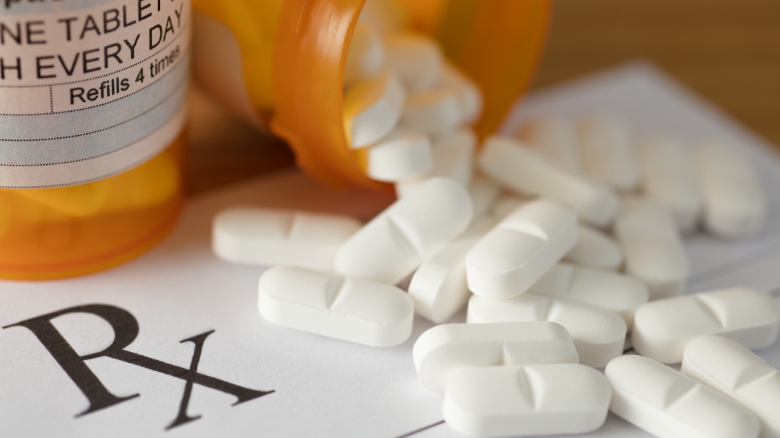 Prescription bottle with medication coming out.