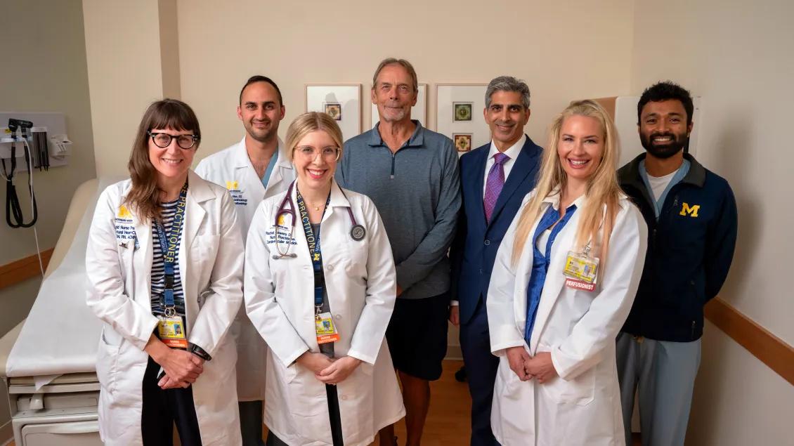 clinical team and patient standing together