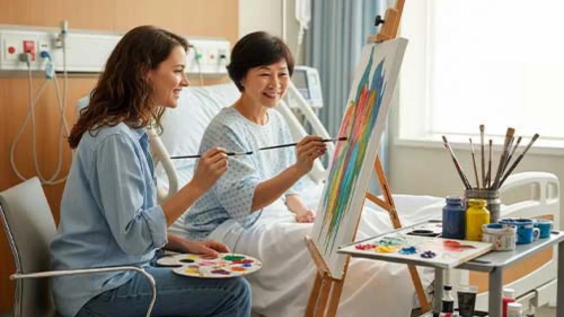 A patient and her visitor paint together