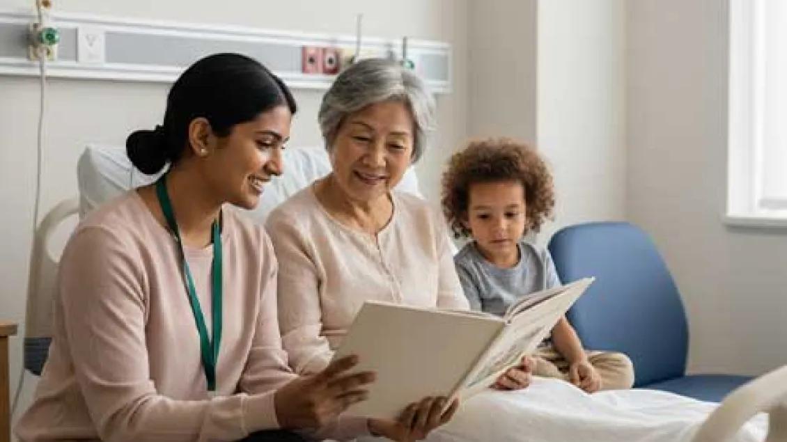 A diverse female healthcare worker reads a book to a smiling elderly woman and a young child in a hospital room, highlighting the bedside story program.