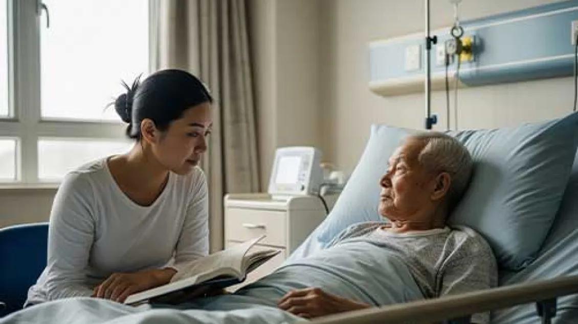 A woman sits besides to a terminally ill man.