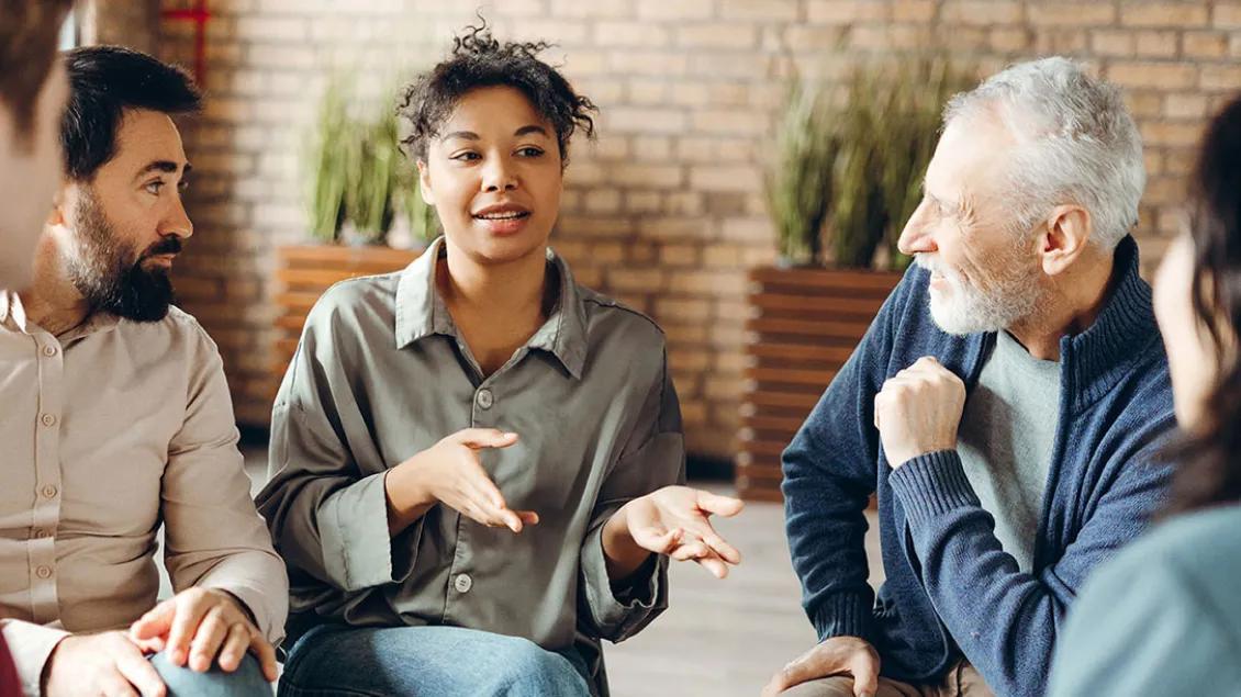 Men and women of all ages and races talk together