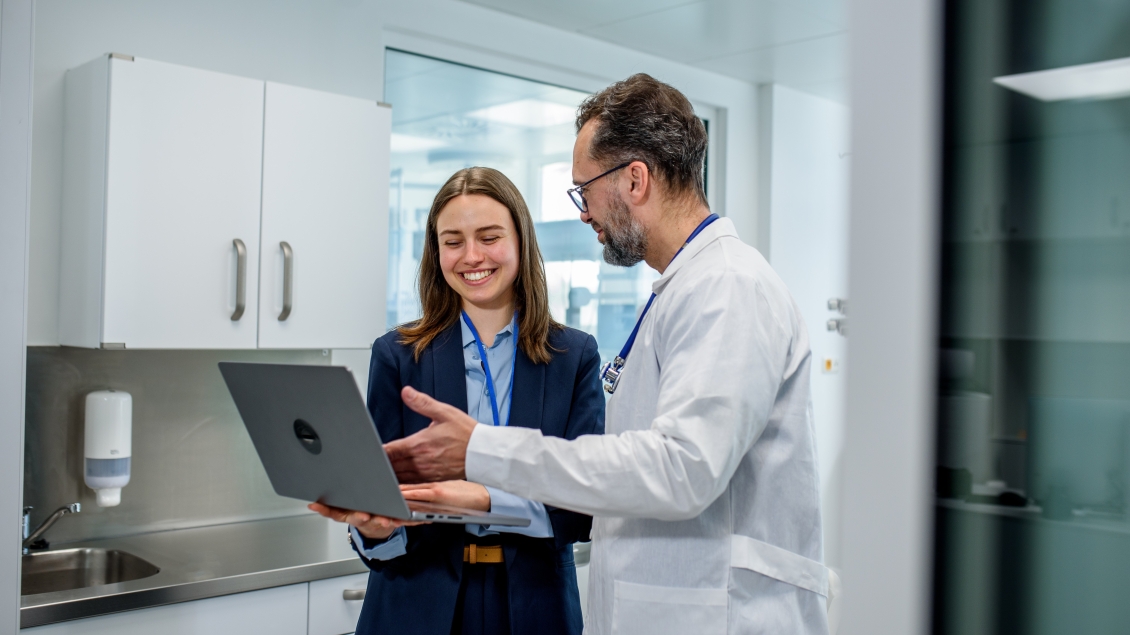 Medical professional and manager reviewing patient data in hospital.
