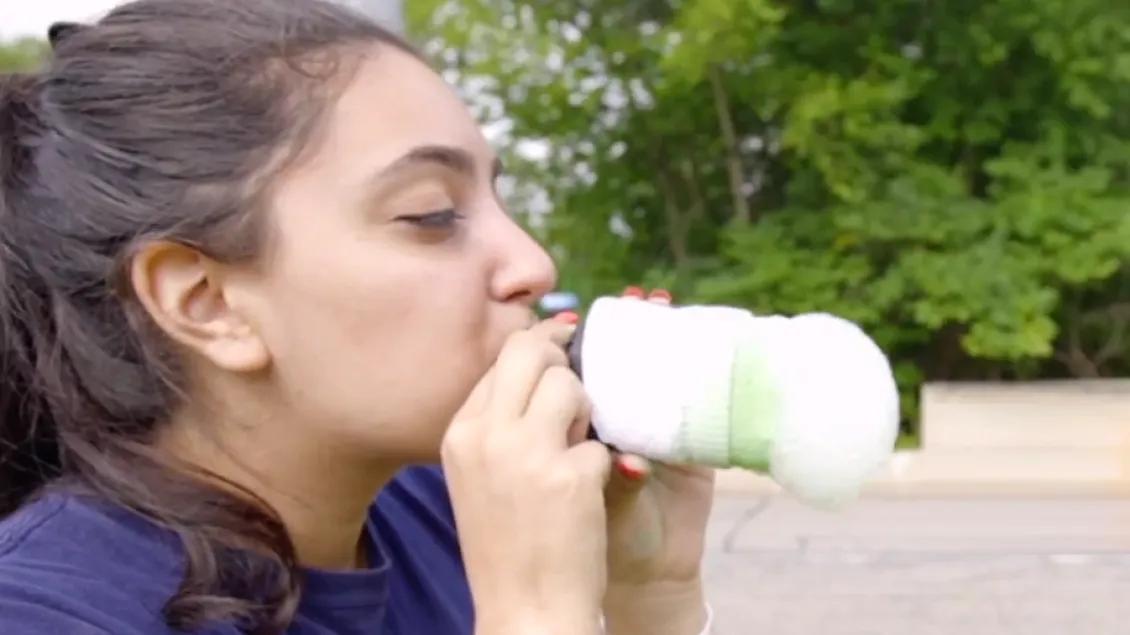 woman blowing bubbles into snake form