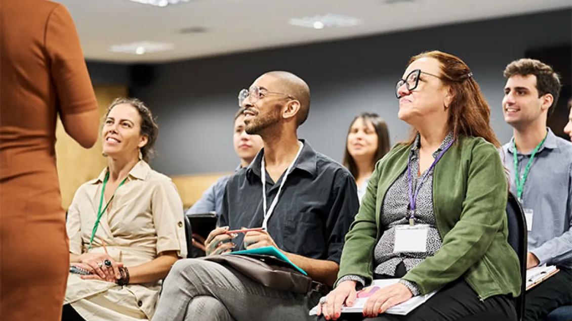 small group of professionals sit and look at speaker
