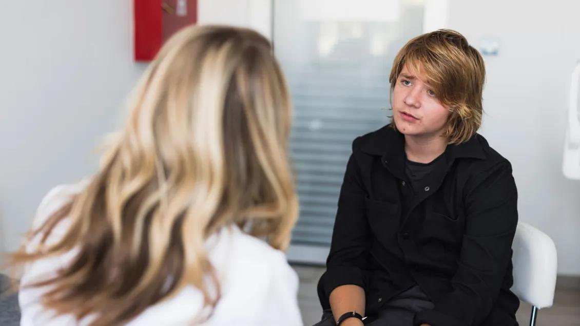 Teen boy talks to female provider