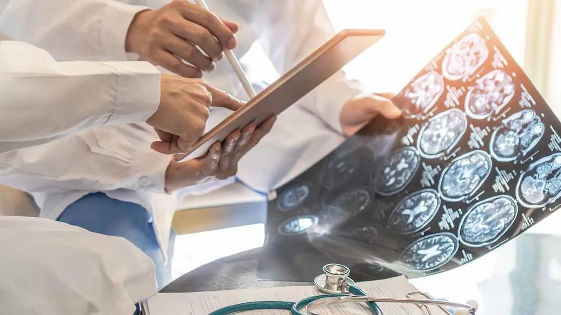 brain scans and doctors white coats pointing
