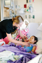 Hospital staff attending to child patient