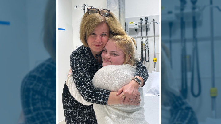 woman hugging patient in exam room
