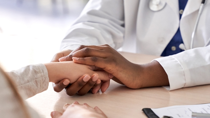 A doctor holding on to a person's hand