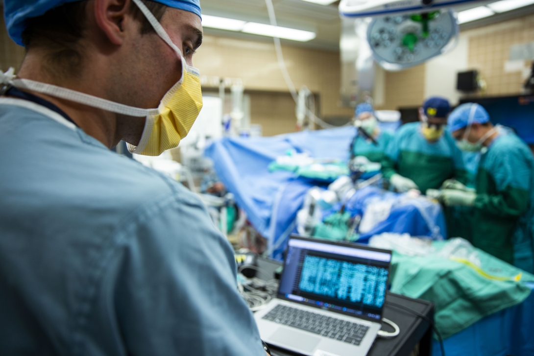 Joseph Costello, Ph.D., sets up the recording system to receive recordings from the brain.
