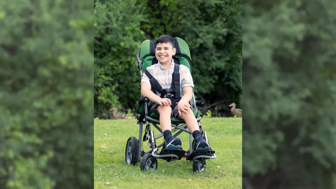 teen in wheelchair seat smiling