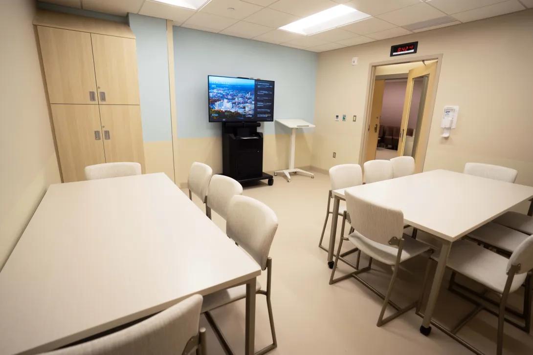 small meeting room at clinic with two tables seating 5 people each
