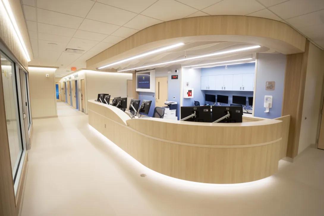 Reception area of Health Center clinic showing large brightly lit desk
