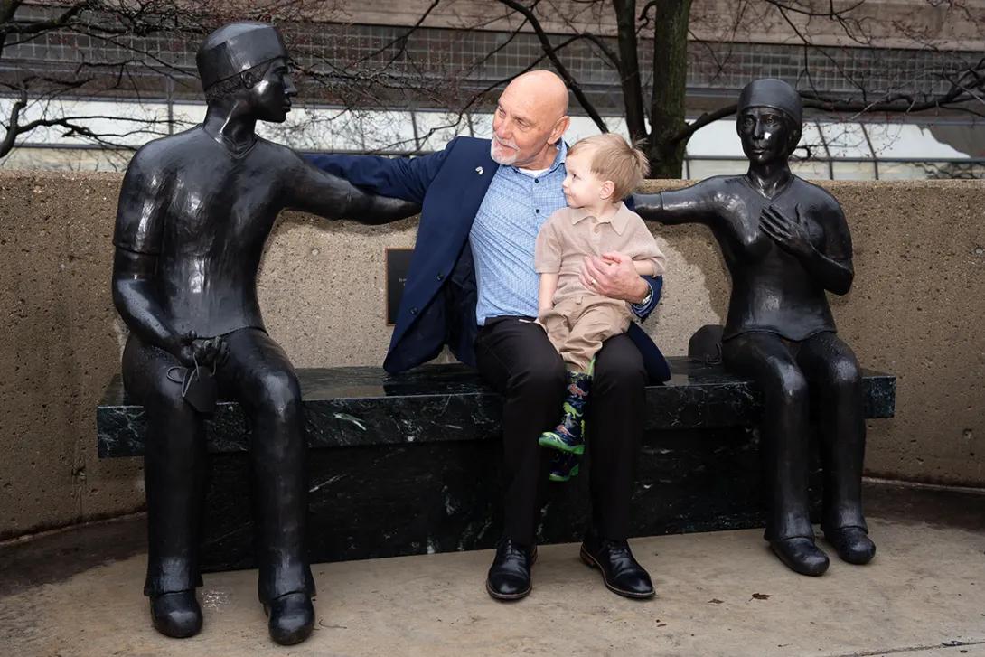 Paul DeWyse and young family member with sculpture