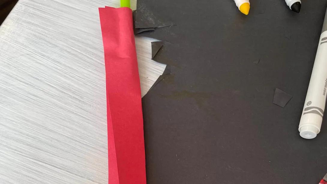 red construction paper wrapped around a straw
