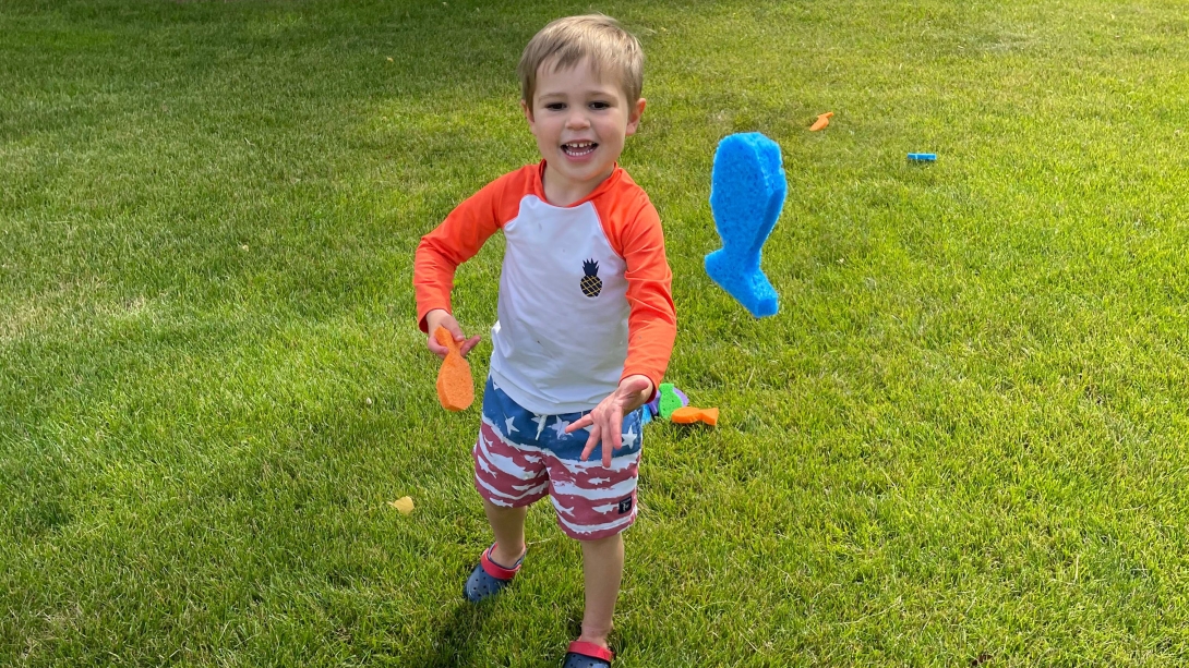 Child catching sponge shaped colored fish