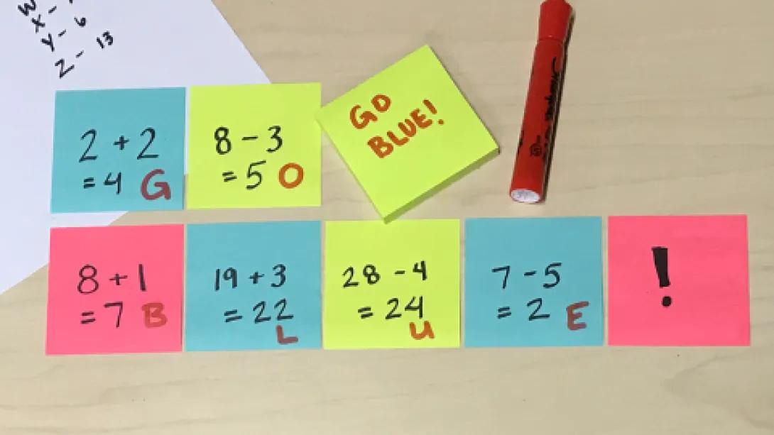 post-its with math equations/code spelling out Go Blue 