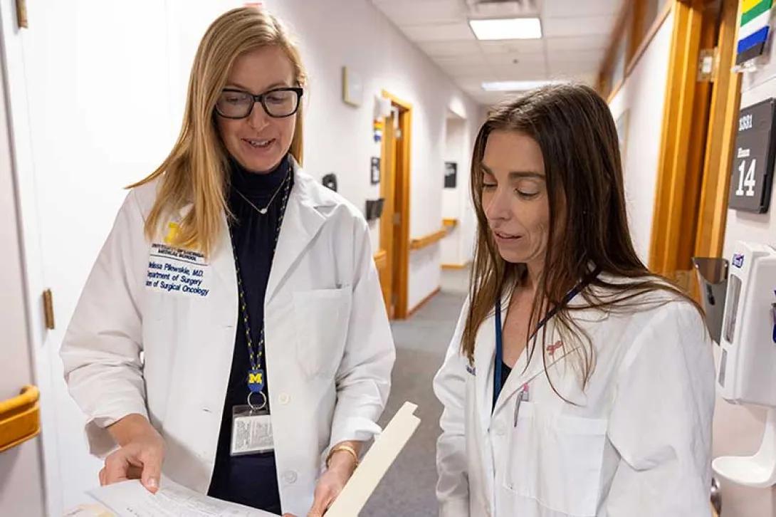Drs. Melissa Pilewski and Monika Burness discuss a patient's care plan