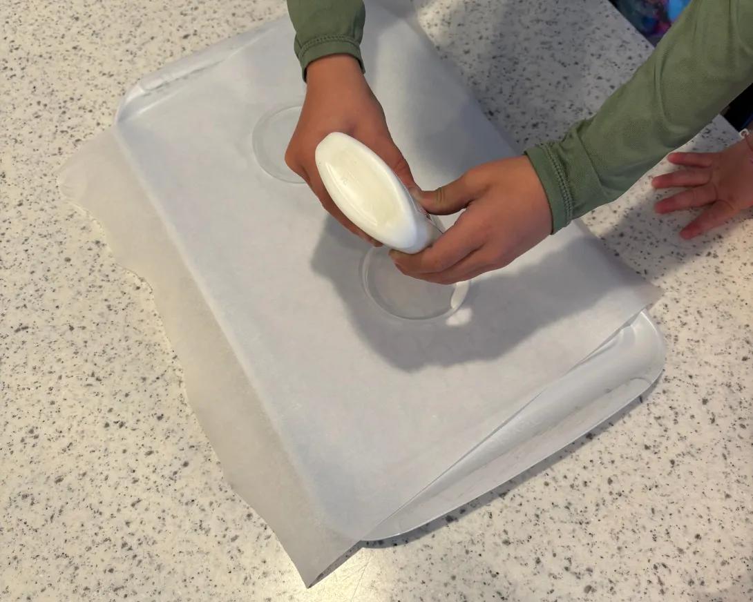 child squeezing craft glue