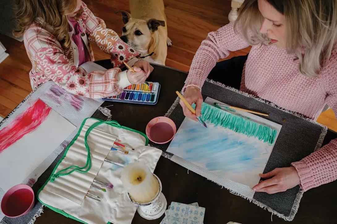 Overhead view of Claire Sloma and her daughter painting together