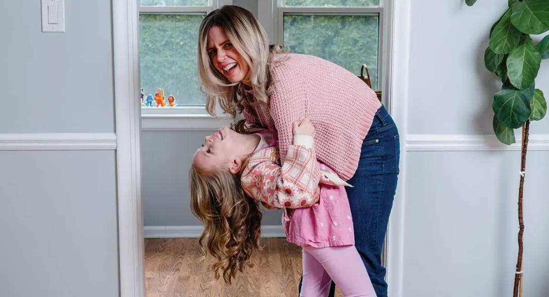 Sloma playing with her daughter