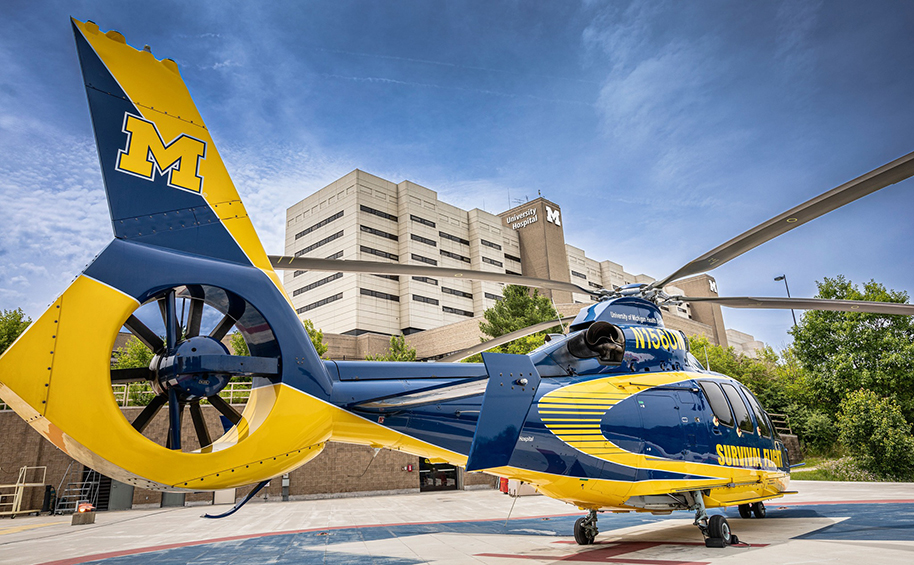 Survival Flight helicopter on the landing pad with the hospital in the background.